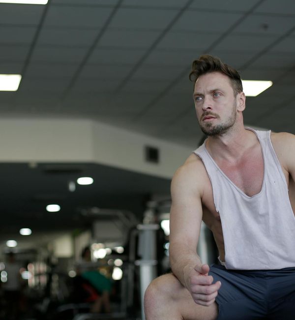 Person sitting peacefully after a workout, looking calm and focused.